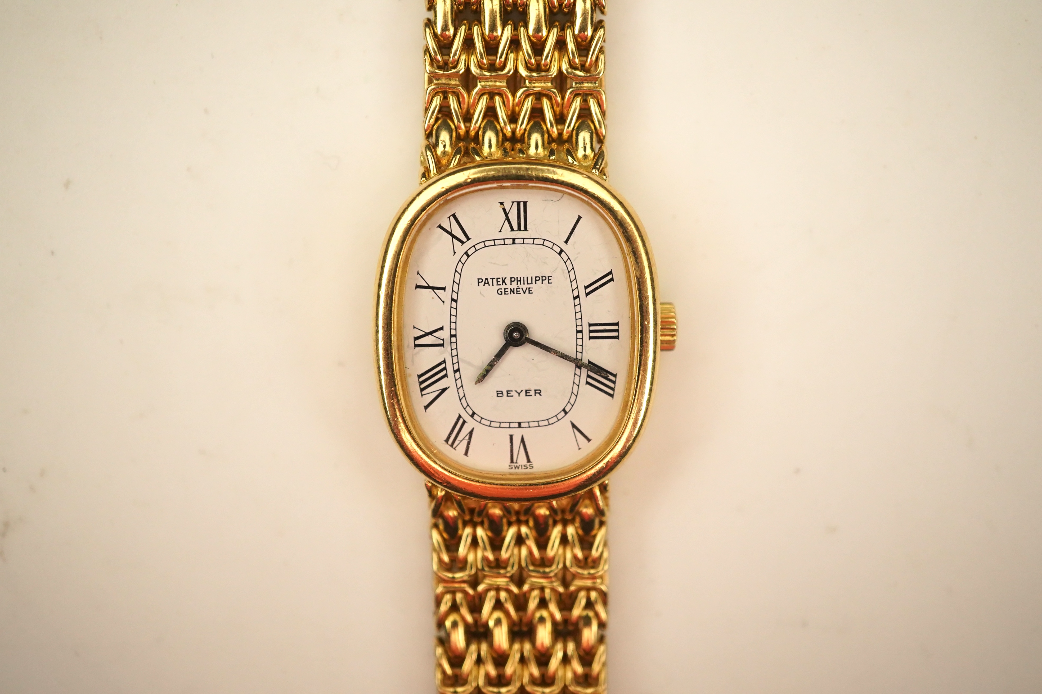 A lady's 18ct gold Patek Philippe manual wind wrist watch, on an integral 18ct gold Patek Philippe bracelet